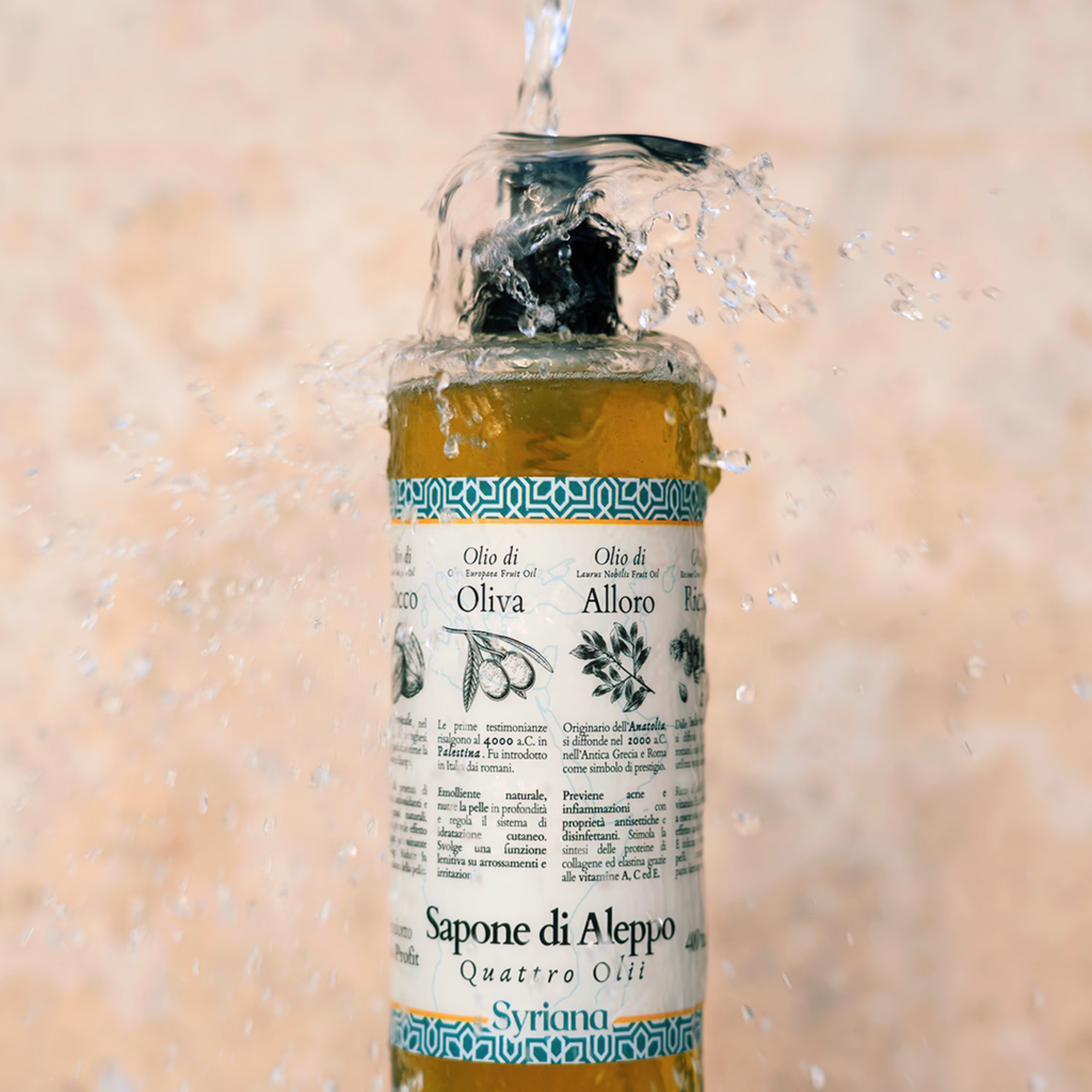 Liquid Aleppo Soap bottle being rinsed with splashing water