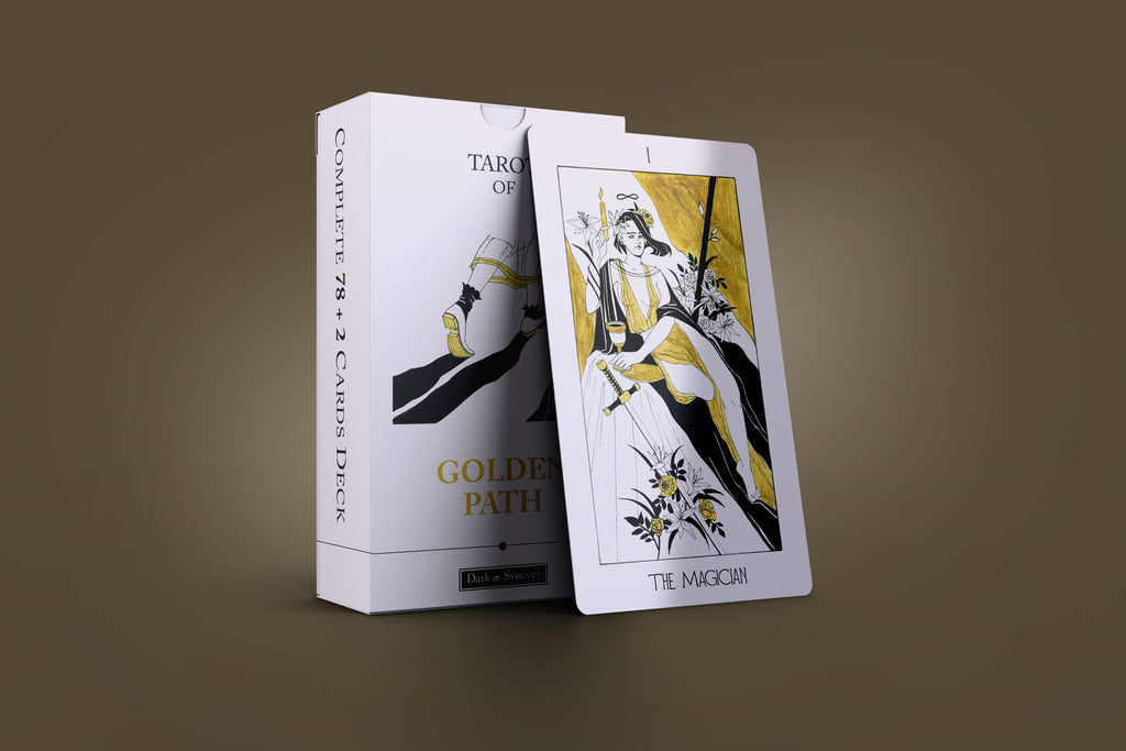 The Golden Path Tarot white tuck box with gold Art Deco design standing next to The Magician card