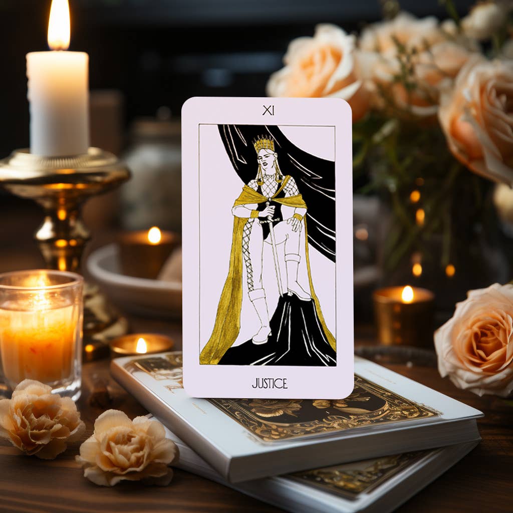 The Golden Path Tarot card Justice displayed with candles and flowers