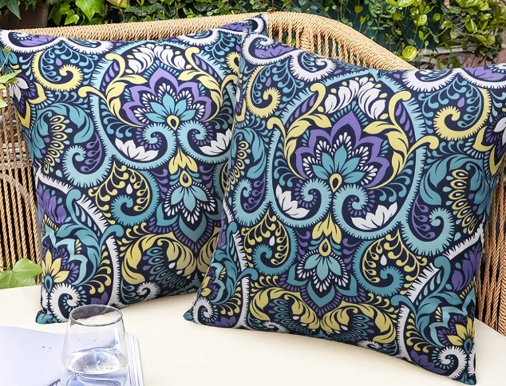 Outdoor Floral Cushion Cover lifestyle view showing pair on wicker patio sofa