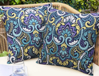 Outdoor Floral Cushion Cover lifestyle view showing pair on wicker patio sofa